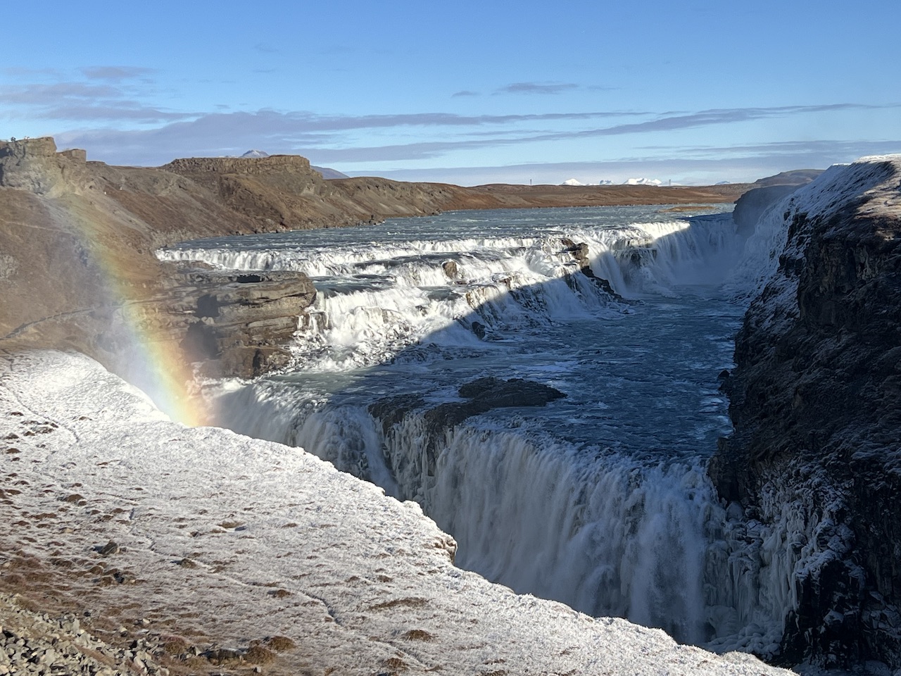 Icy waterfall with rainbow